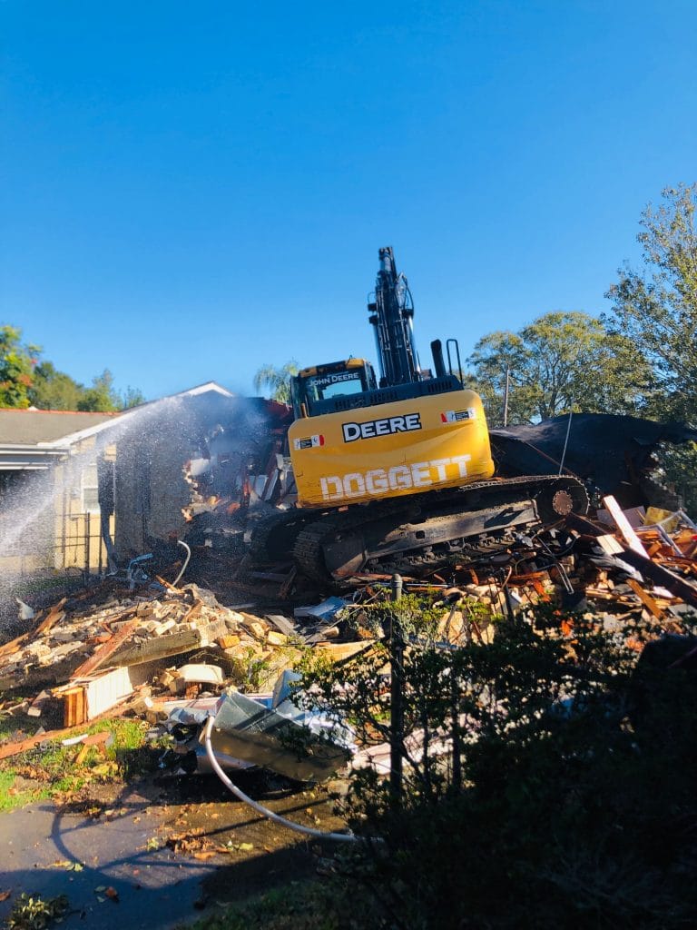 Excavator over a house -Big Easy Concrete