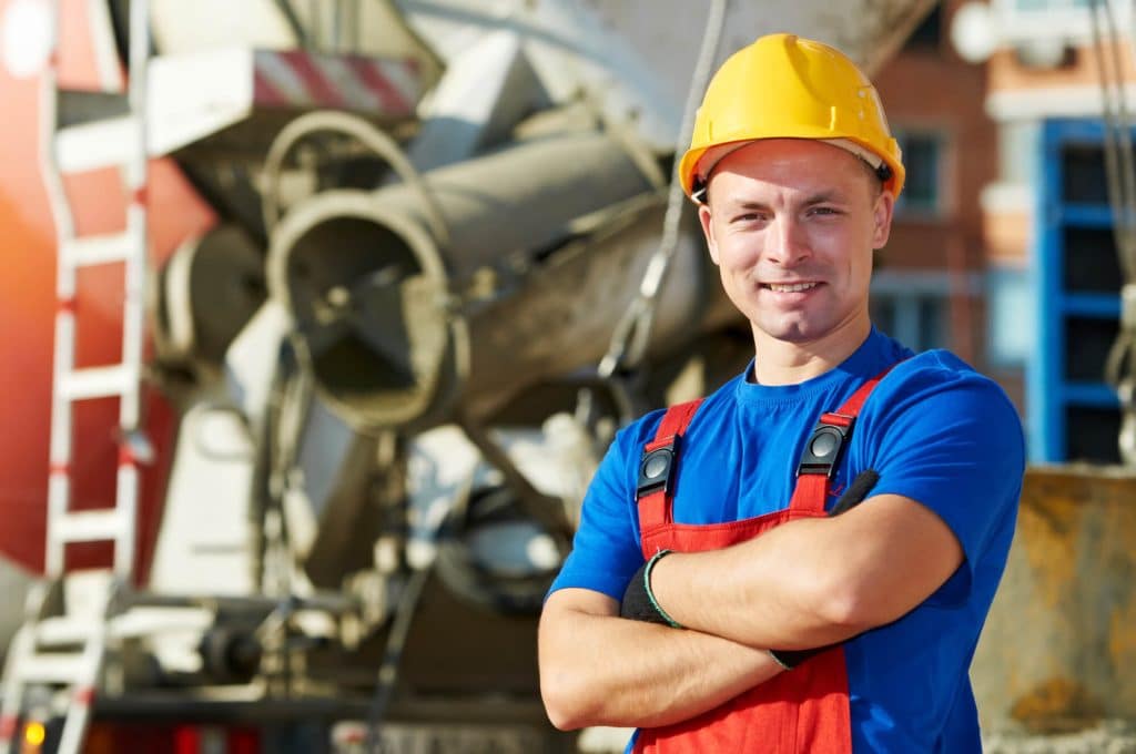 a contractor with cement mixer in the background