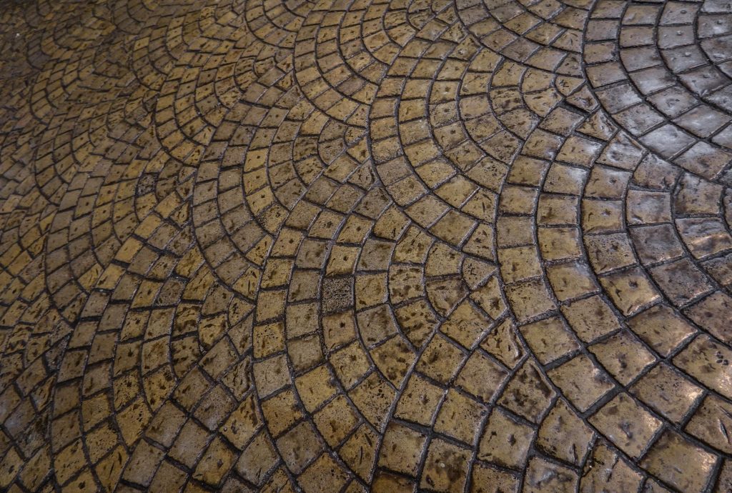 Cobblestone-pattern stamped concrete with circular detail
