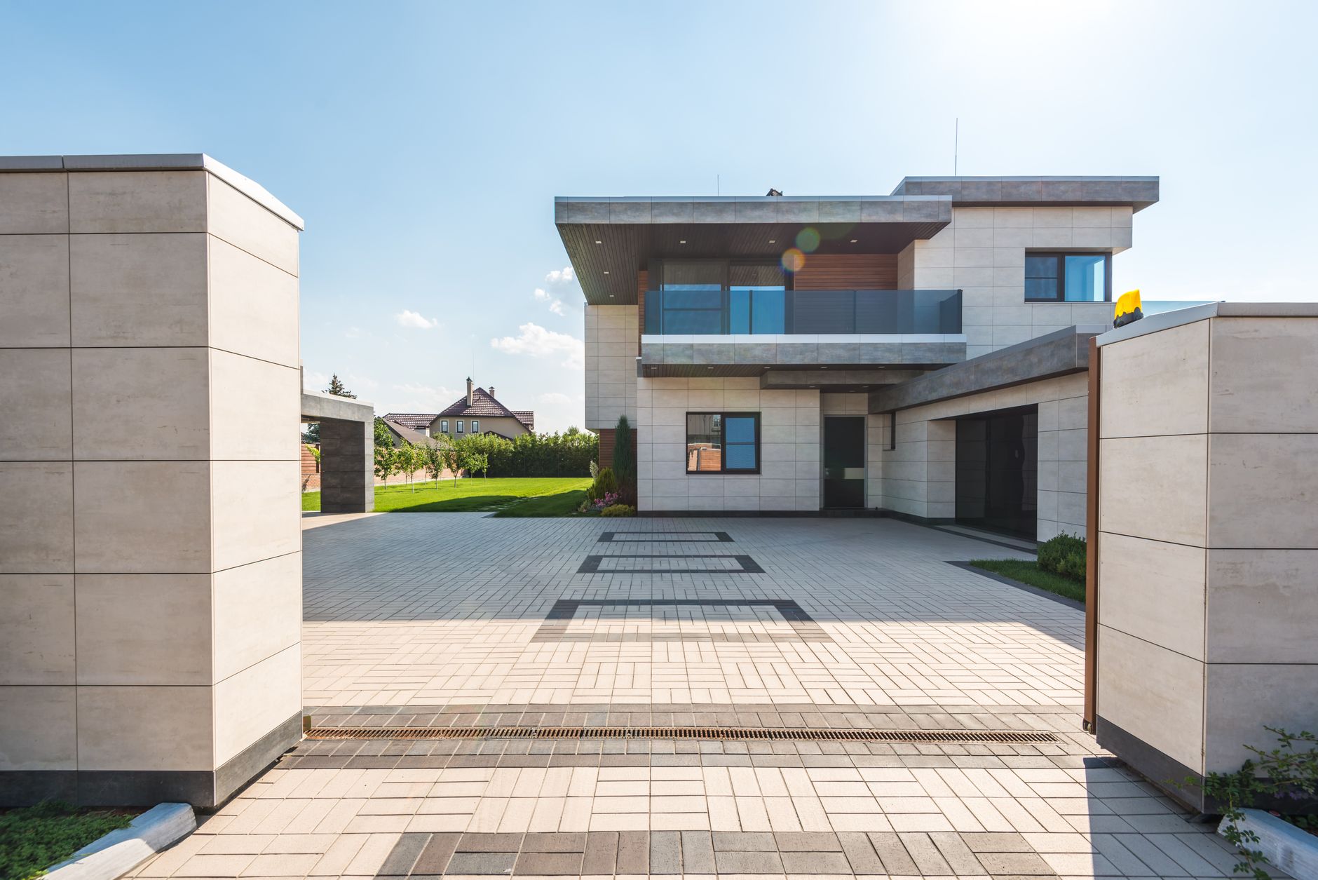 Luxury home with a paved decorative concrete driveway