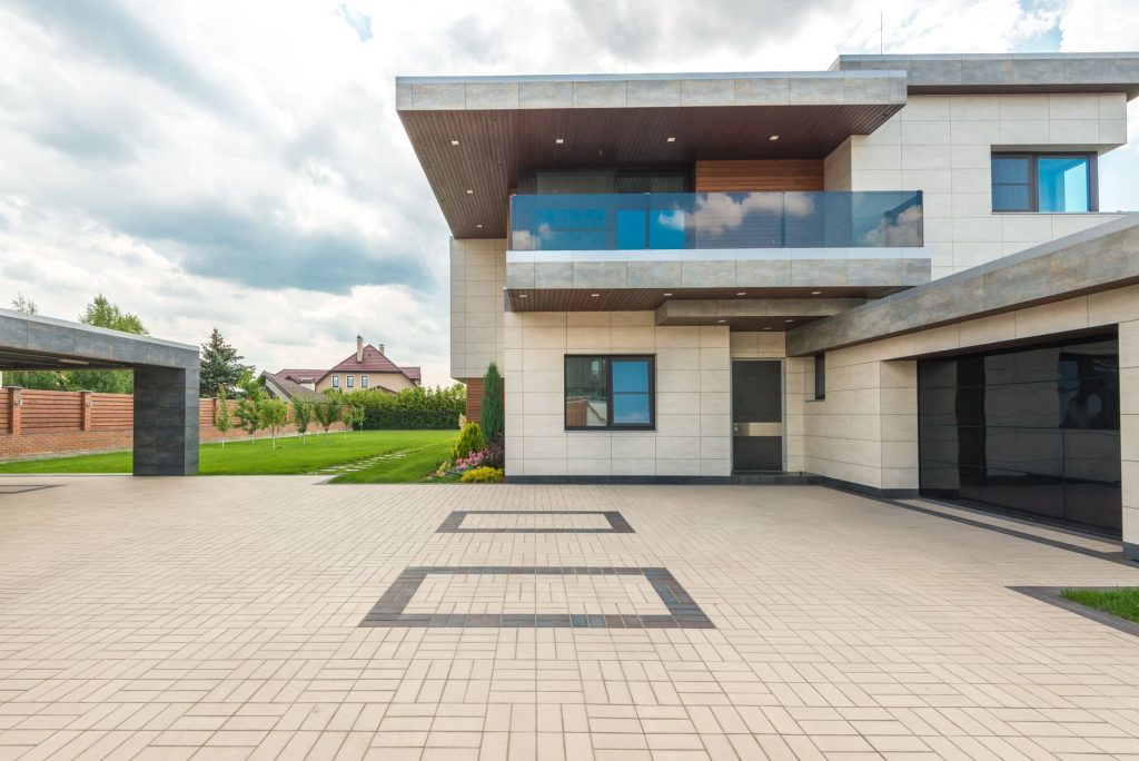 Warm gray concrete driveway complementing a modern home exterior
